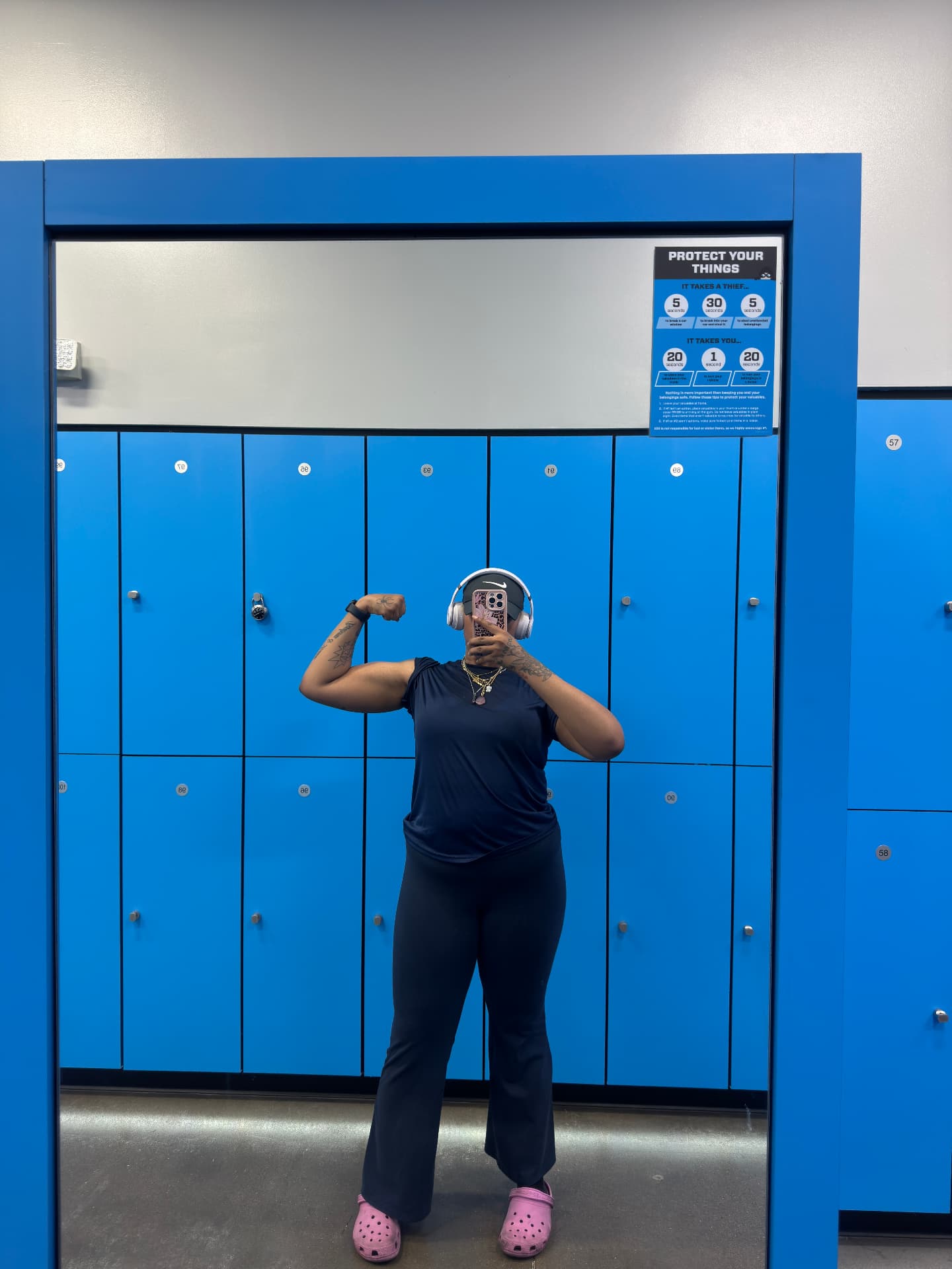Taya flexing in the gym locker room